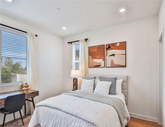 bedroom featuring wood-type flooring and multiple windows