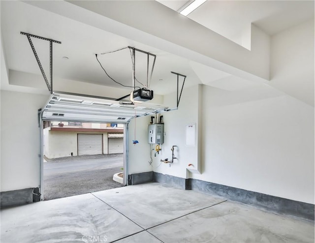 garage with electric water heater and a garage door opener