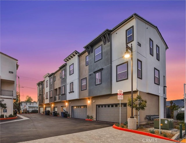 outdoor building at dusk with a garage