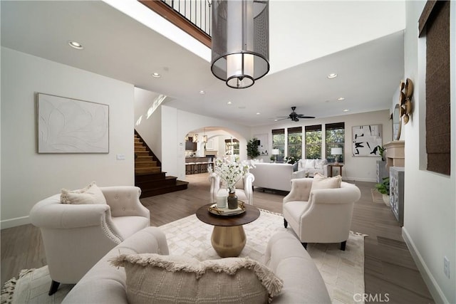 living room with ceiling fan and wood-type flooring