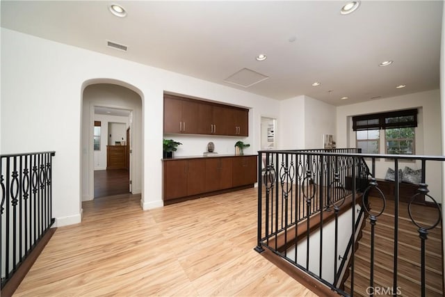 102 Catalonia, Irvine, CA 92618 - hallway featuring recessed lighting, light wood finished floors, visible vents, an upstairs landing, and arched walkways