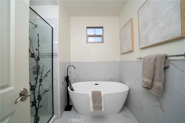 bathroom with separate shower and tub and tile walls