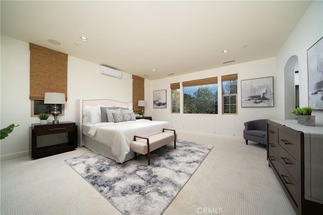 102 Catalonia, Irvine, CA 92618 - bedroom with light carpet, arched walkways, a wall mounted AC, and recessed lighting