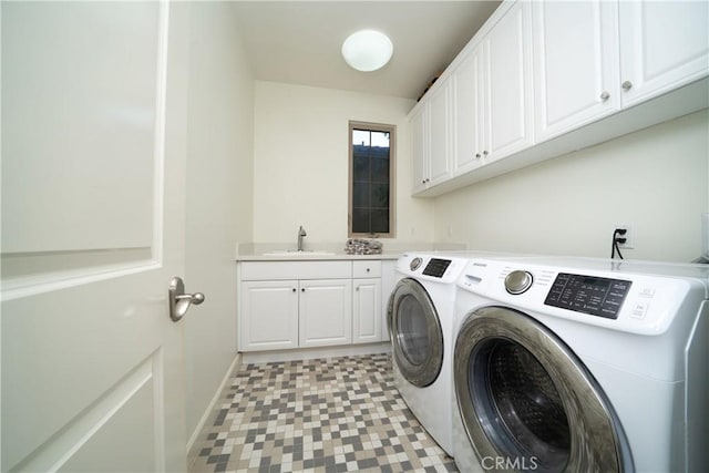 washroom with cabinets, separate washer and dryer, and sink