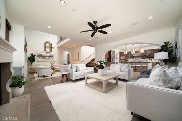 102 Catalonia, Irvine, CA 92618 - living area with stairway, a ceiling fan, wood finished floors, arched walkways, and recessed lighting