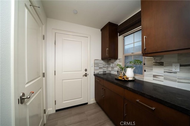 kitchen with decorative backsplash and dark brown cabinets