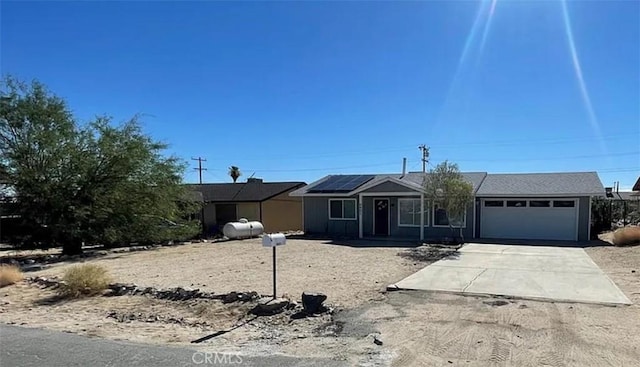 single story home featuring a garage and solar panels