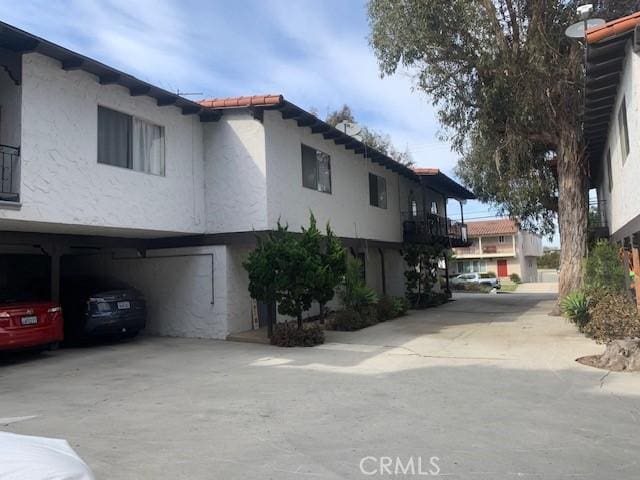 view of property exterior featuring driveway and stucco siding