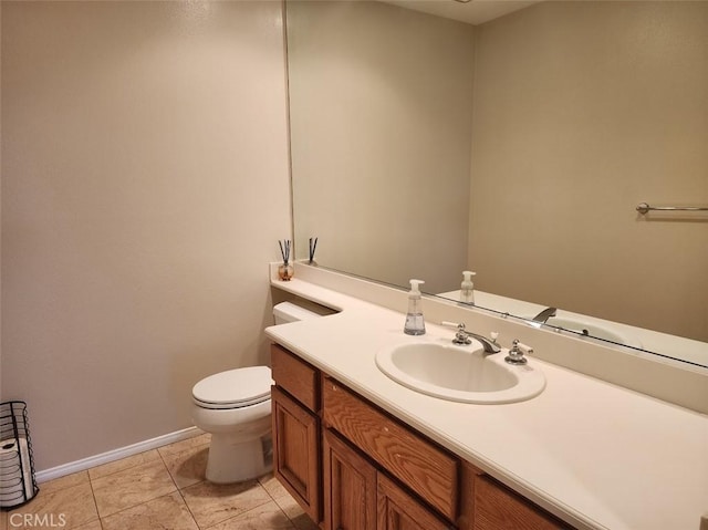 bathroom featuring tile patterned floors, vanity, and toilet