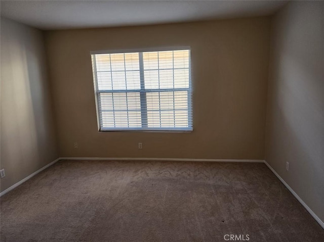 empty room with dark colored carpet