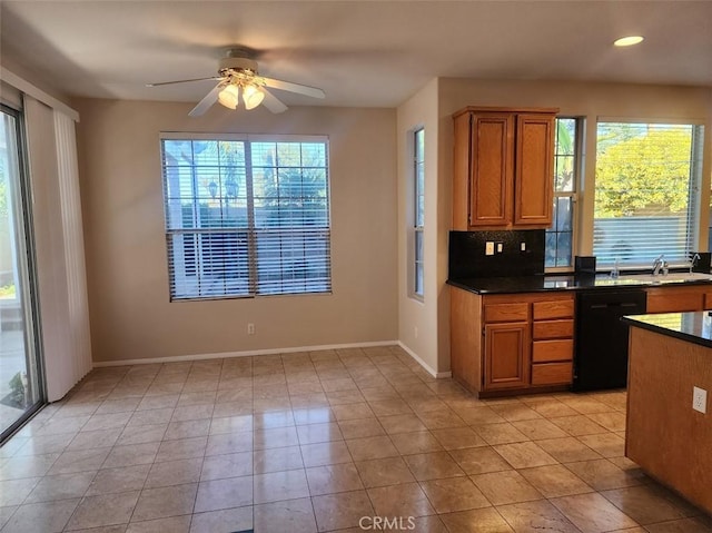 kitchen featuring backsplash, ceiling fan, sink, light tile patterned floors, and black dishwasher