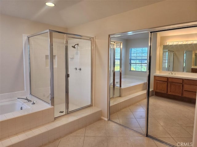 bathroom with tile patterned floors, plus walk in shower, and vanity