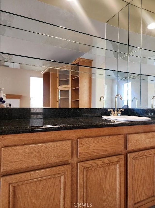 kitchen featuring dark stone countertops and sink