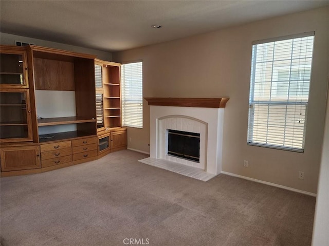 unfurnished living room featuring light colored carpet