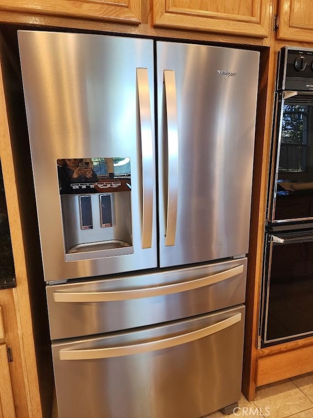 details featuring stainless steel refrigerator with ice dispenser and double oven