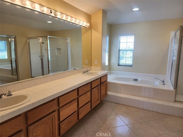 bathroom featuring tile patterned flooring, vanity, and independent shower and bath