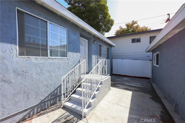 property entrance featuring a patio