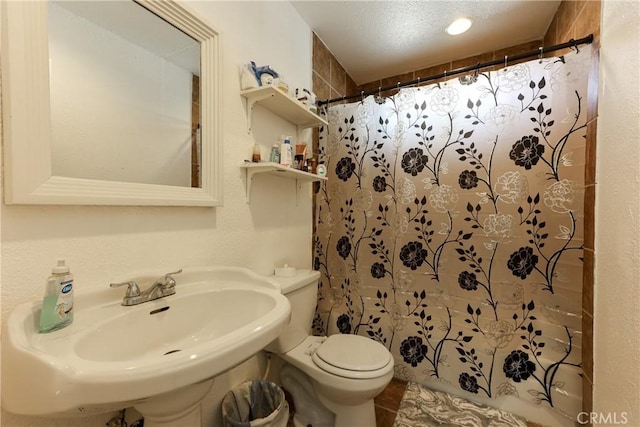 bathroom with sink, tile patterned floors, toilet, and a shower with shower curtain