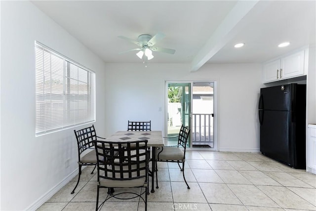 tiled dining space featuring beamed ceiling and ceiling fan