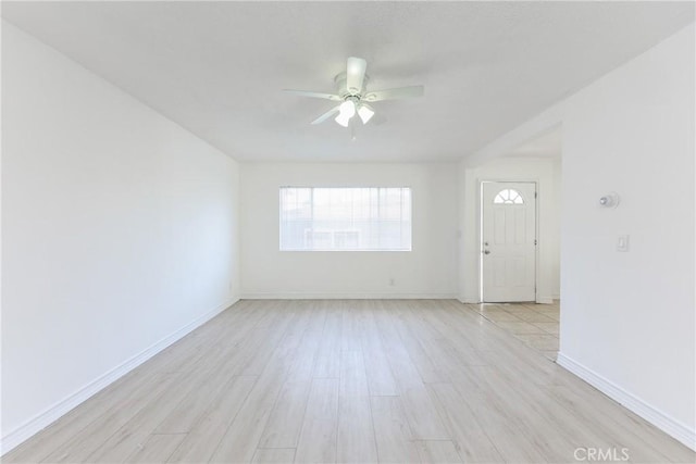 spare room featuring ceiling fan and light hardwood / wood-style flooring