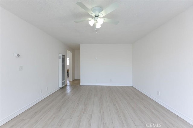 spare room featuring ceiling fan and light wood-type flooring