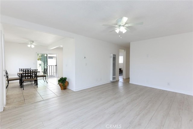 spare room with ceiling fan and light wood-type flooring