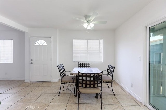 tiled dining area with ceiling fan