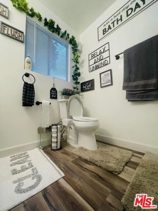 bathroom featuring hardwood / wood-style flooring and toilet