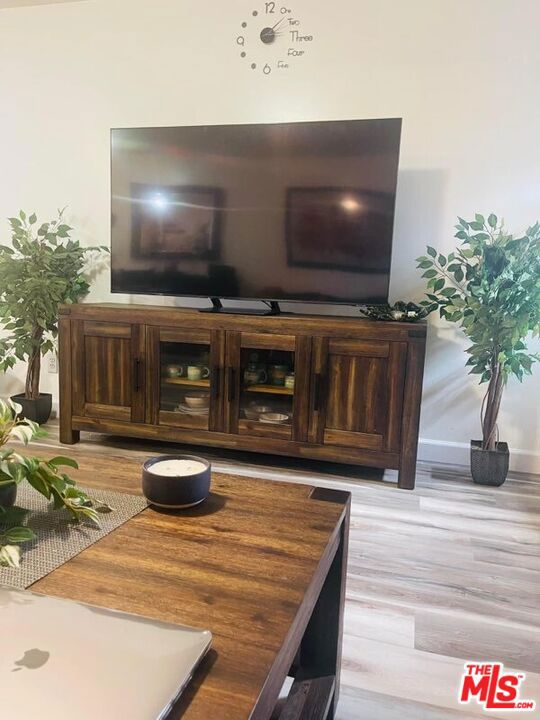 bar featuring light hardwood / wood-style floors