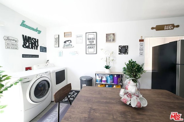 clothes washing area with washer and clothes dryer