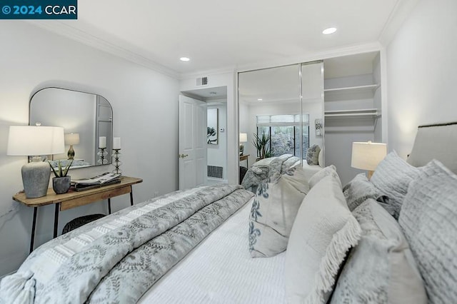 bedroom with a closet and ornamental molding