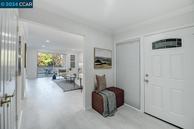 entrance foyer with light hardwood / wood-style floors and ornamental molding