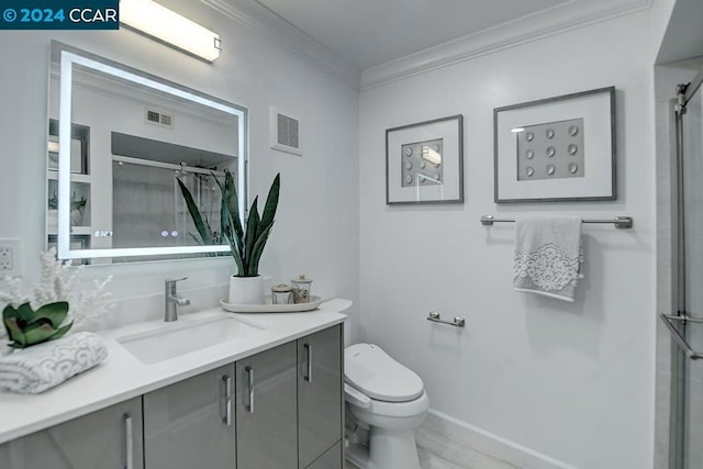 bathroom with toilet, vanity, a shower with shower door, and ornamental molding