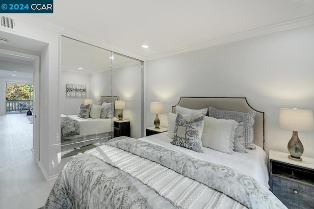 bedroom with hardwood / wood-style flooring and ornamental molding