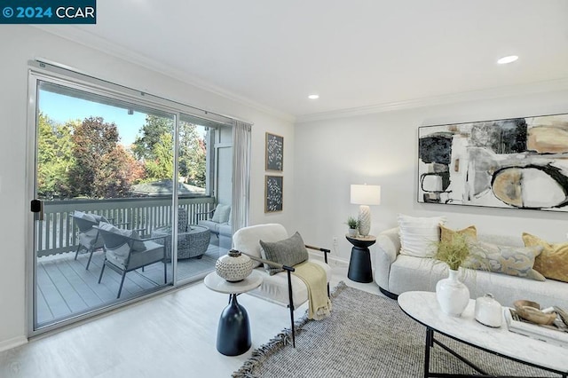 living room with hardwood / wood-style flooring and ornamental molding