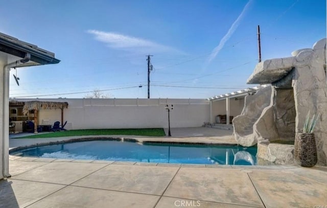 view of swimming pool featuring a patio area, fence, and a fenced in pool