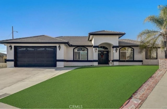 view of front of property featuring driveway, an attached garage, a tiled roof, and stucco siding