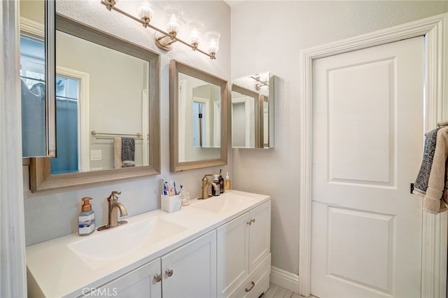 full bathroom featuring double vanity and a sink