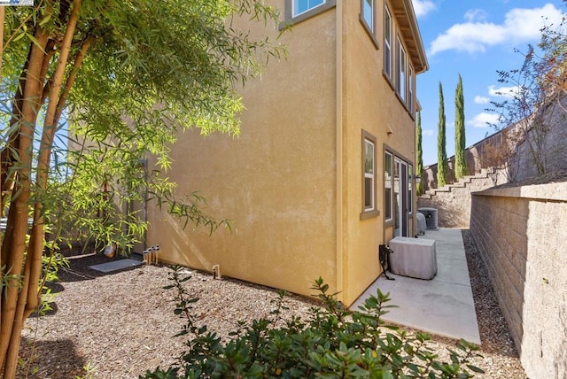 view of home's exterior featuring central AC and a patio area