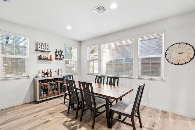 dining room with a wealth of natural light and light hardwood / wood-style flooring