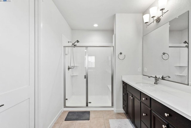 bathroom with tile patterned flooring, vanity, and a shower with shower door