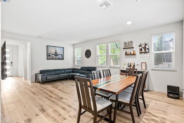 dining area with light hardwood / wood-style floors and plenty of natural light