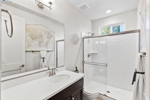 bathroom with vanity, toilet, and walk in shower