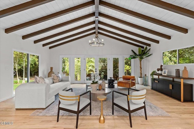 living room featuring light hardwood / wood-style flooring, a healthy amount of sunlight, and an inviting chandelier