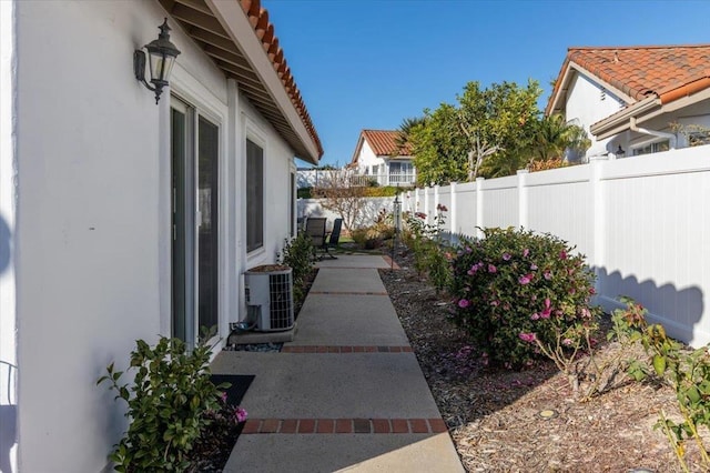 view of yard with central AC unit and a patio