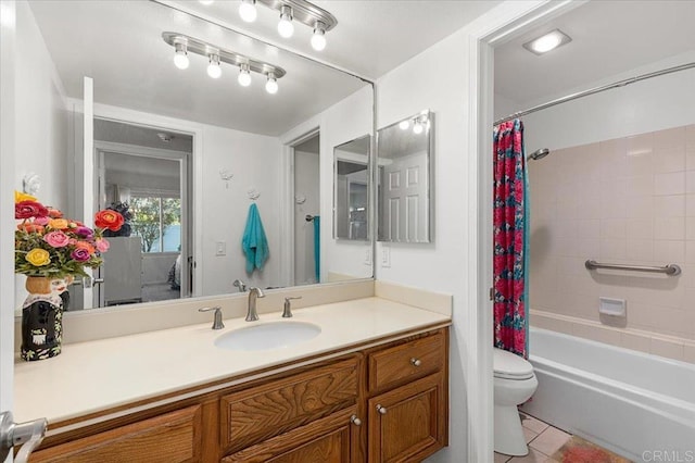 full bathroom with tile patterned flooring, vanity, shower / bath combo with shower curtain, and toilet