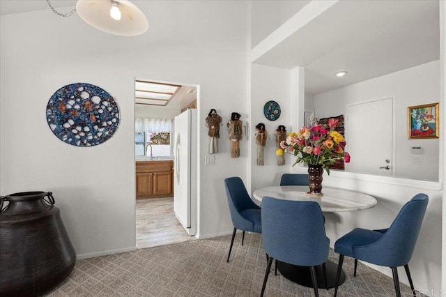 carpeted dining space featuring sink