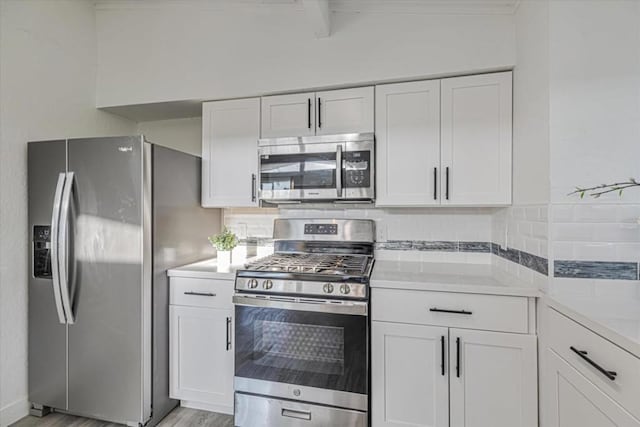 kitchen featuring white cabinetry, beam ceiling, stainless steel appliances, light stone countertops, and light hardwood / wood-style floors