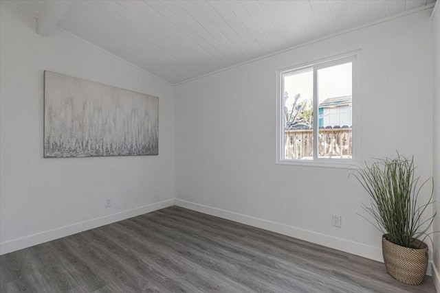 spare room with vaulted ceiling with beams, wood ceiling, and dark hardwood / wood-style floors