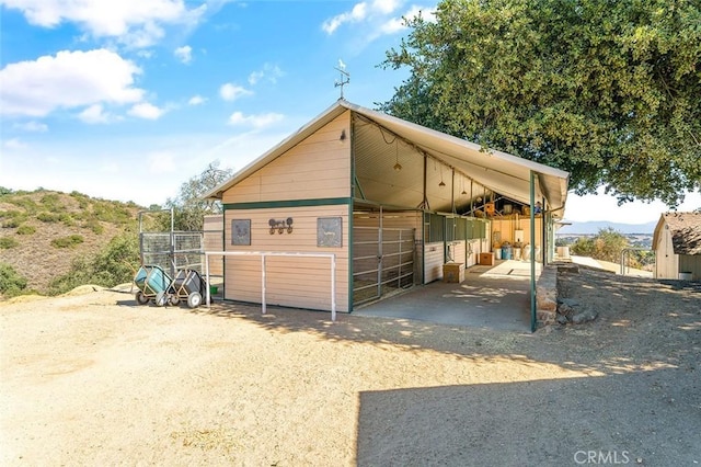 view of horse barn featuring a mountain view